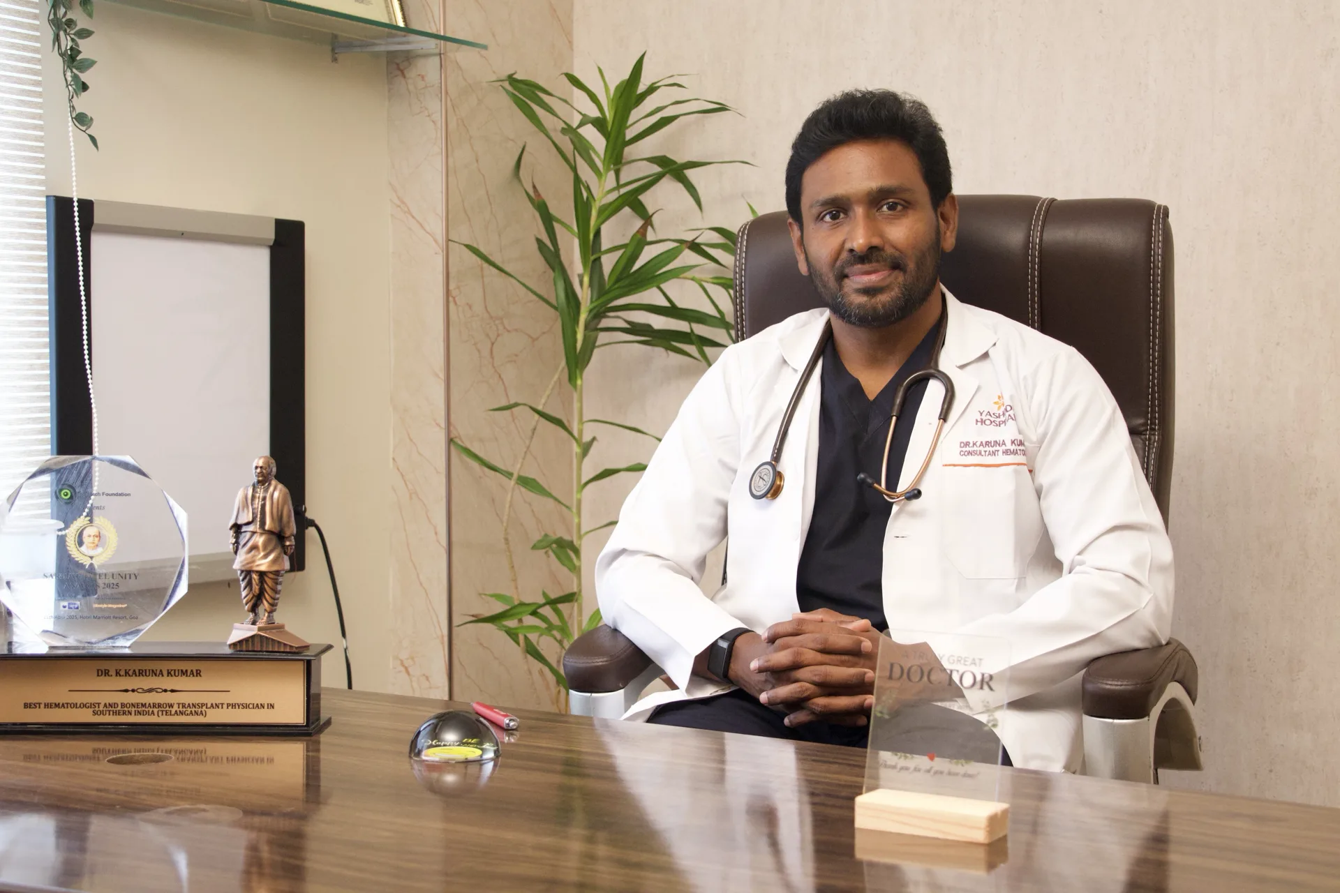 Dr Karuna Kumar at his desk at Dr KK Hematology Clinic